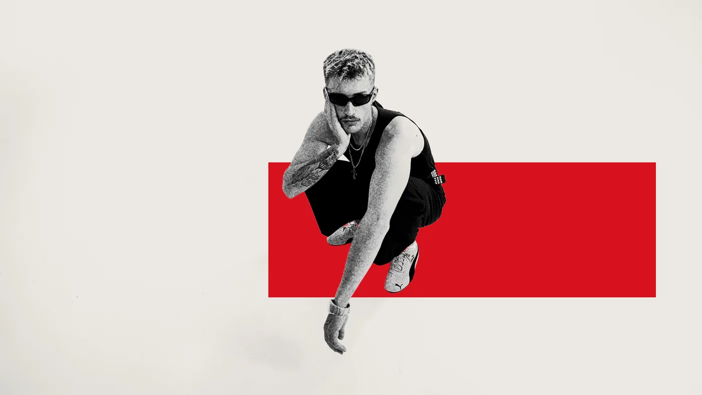 George Radsport crouching in front of a red block, black and white on a light background